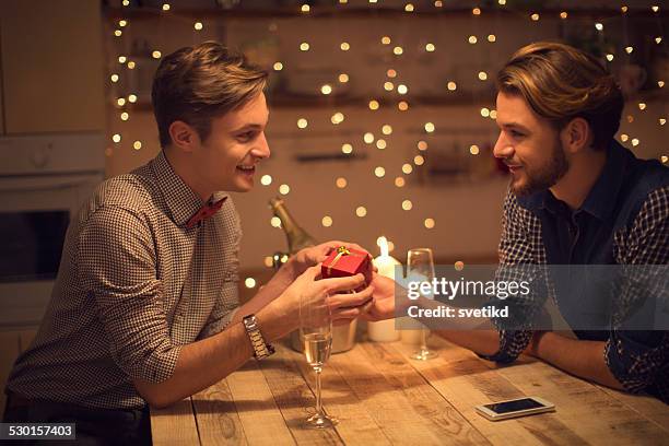 loving gay couple celebrating valentine's day. - champange bottle and valentines day stock pictures, royalty-free photos & images