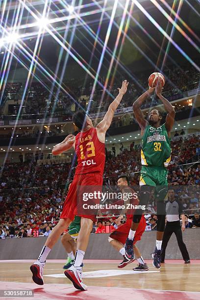 Mickell Gladness of Australia drives to the basket against Li Muhao of China during Internationl Basketball Challenge match between the Chinese...