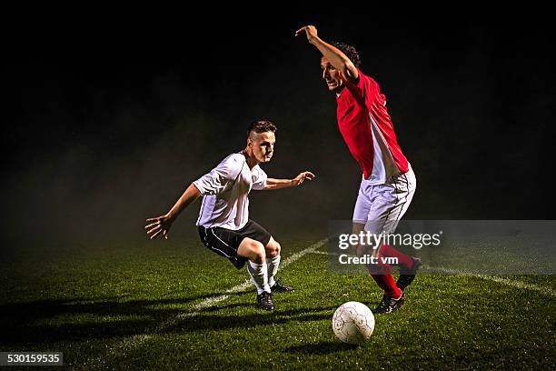 soccer players in action - soccer dribbling stock pictures, royalty-free photos & images