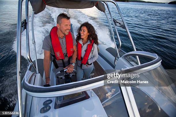 couple driving motorboat - boat gps stockfoto's en -beelden