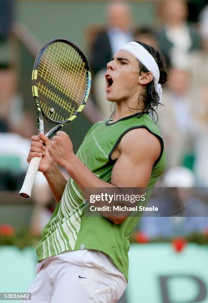 Rafael Nadal of Spain celebrates match point as he defeats Roger Federer of Switzerland in four sets during his semi-final match on the twelfth day...