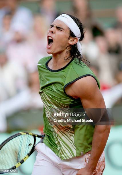 Rafael Nadal of Spain celebrates match point as he defeats Roger Federer of Switzerland in four sets during his semi-final match on the twelfth day...