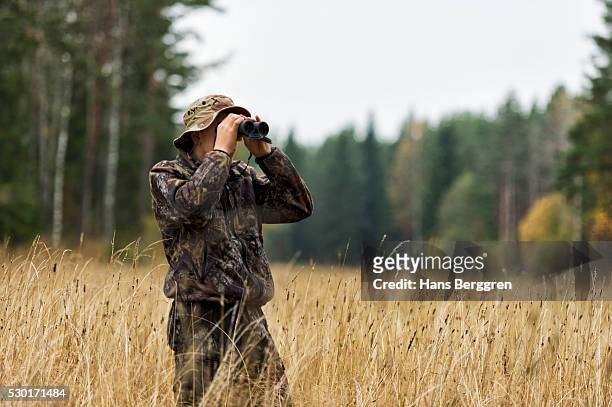 teenager with binoculars watching forest - spy hunter stock pictures, royalty-free photos & images