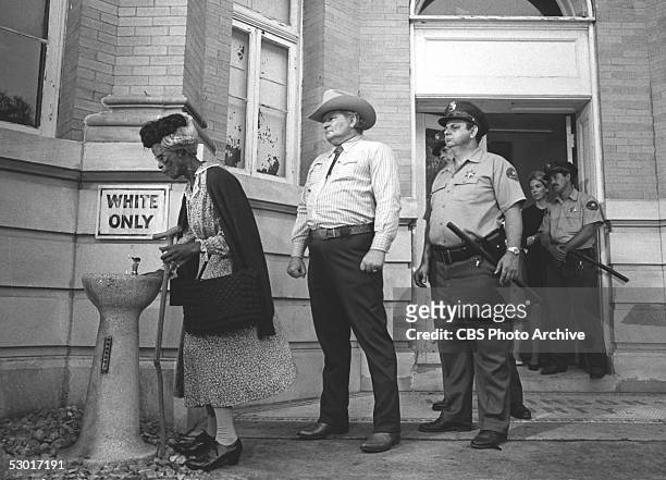 American actress Cicely Tyson takes a drink from a 'whites only' water fountain to the consternation of the local authorities in the...