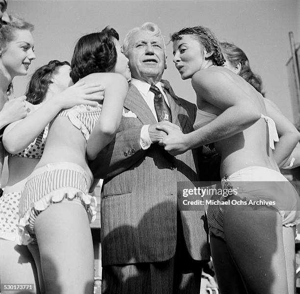 Film Director Mack Sennett poses with his Sennett Bathing Beauties in Los Angeles,CA.