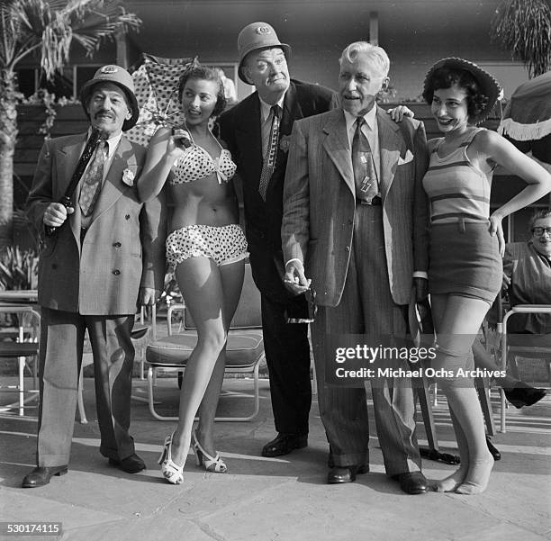 Keystone Cops and Sennett Bathing Beauties pose with Film Director Mack Sennett in Los Angeles,CA.