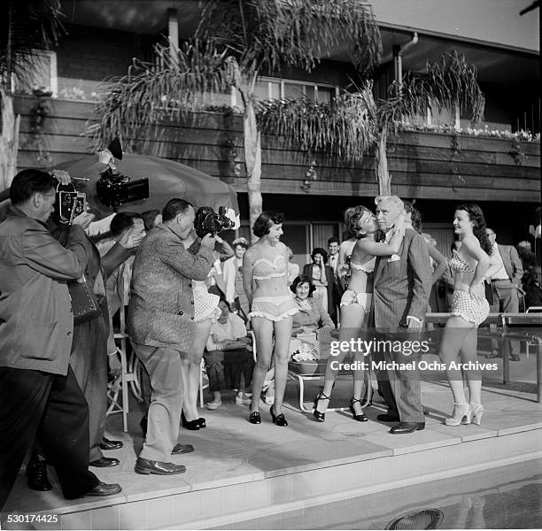 Sennett Bathing Beauties kiss Mack Sennett during a filming session in Los Angeles,CA.