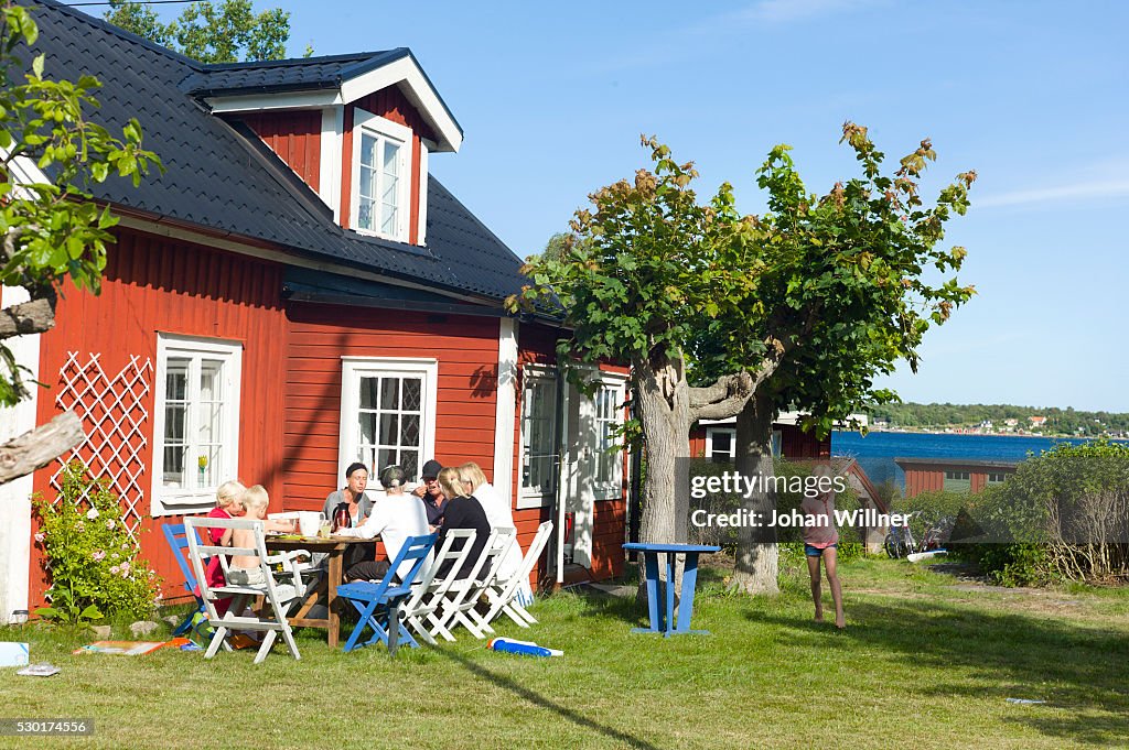 Family having meal in front of house