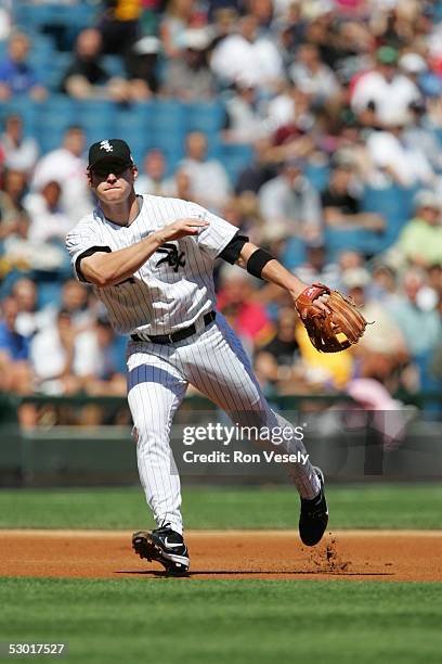 Joe Crede, #24 of the Chicago White Sox fields the ball at third base and throws to first during the game against the Los Angeles Angels at U.S....