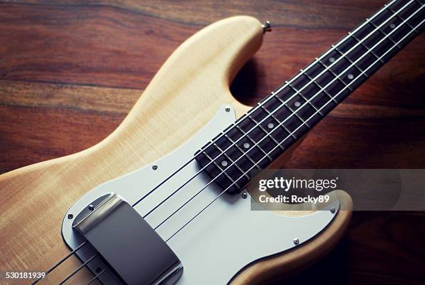 amazing shot of a bass guitar with natural finish - fender guitar stock pictures, royalty-free photos & images