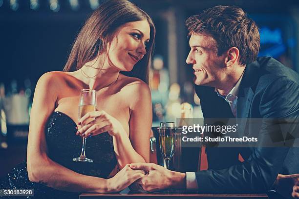 coppia godendo di champagne - abbigliamento elegante foto e immagini stock