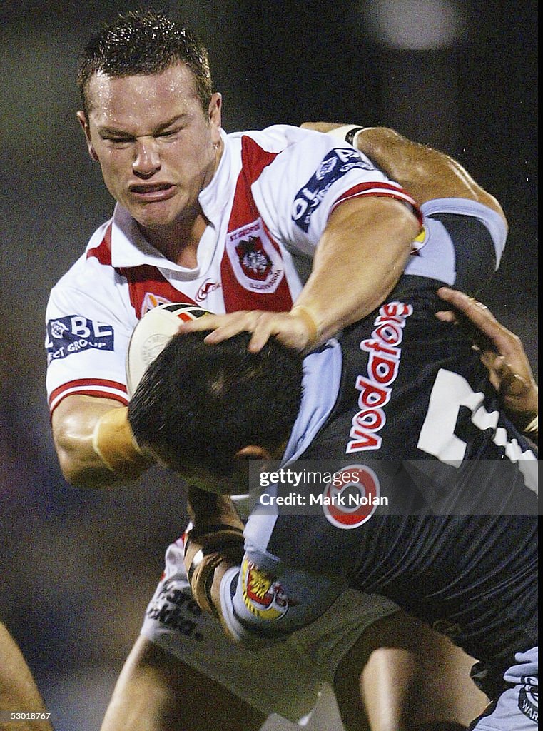 Nolan Stringer Dean Young of the Dragons palms off Stacey Jones of the Warriors ...
