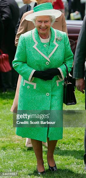 Britain's Queen Elizabeth II arrives at the Epsom Festival at Epsom Downs racecourse on June 4, 2005 in Surrey, England.