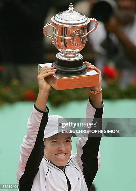 Belgium Justine Henin-Hardenne holds her trophy after her women's final match of the tennis French Open at Roland Garros against French Mary Pierce,...