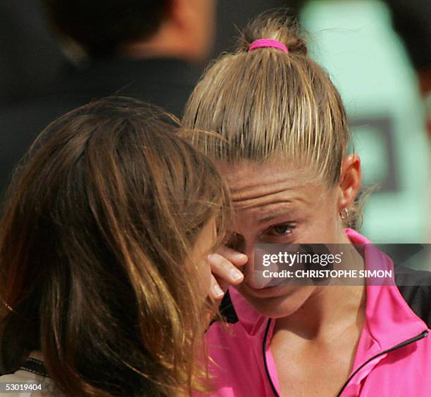 French Mary Pierce cries next to French Swimming Olympic champion Laure Manaudou after her women's final match of the tennis French Open at Roland...