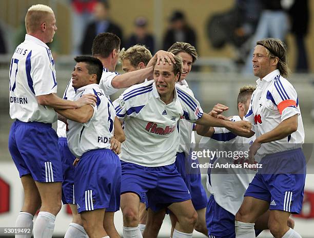 Rene Mueller of Paderborn celebrates with his teammates after scoring the second goal during the Third Bundesliga match between VfL Wolfsburg...