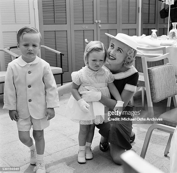 Actress Celeste Holm, with two young children attend the opening of the Esther Williams Swim School at the Hilton Hotel in Los Angeles,CA.