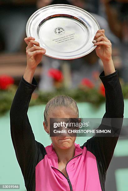 French Mary Pierce cries as she holds her trophy after her women's final match of the tennis French Open at Roland Garros against Belgium Justine...
