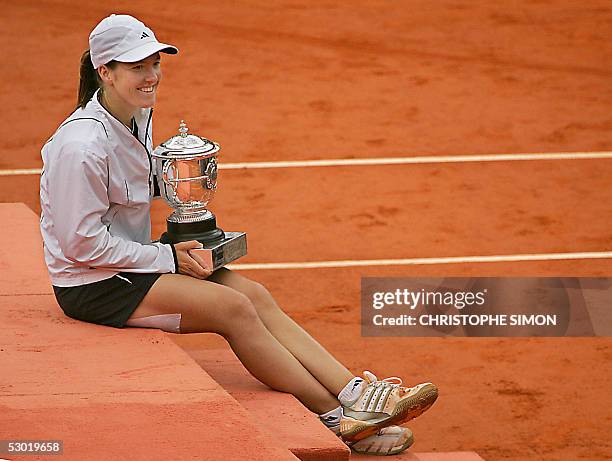 Belgium Justine Henin-Hardenne poses with her trophy after her women's final match of the tennis French Open at Roland Garros against French Mary...