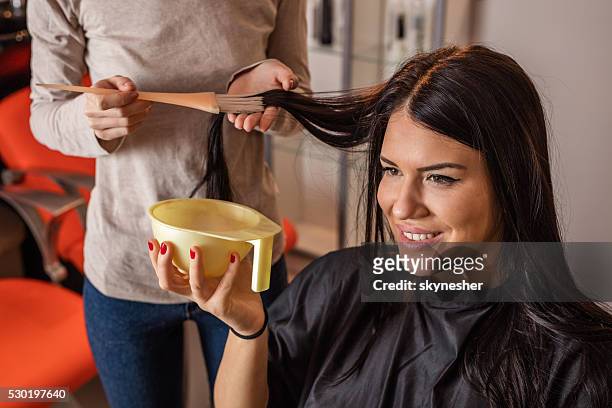young happy woman getting her hair dyed at home. - dye stock pictures, royalty-free photos & images