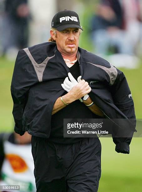 Miguel Angel Jimenez of Spain covers up as the wind picks up during the third round of The Celtic Manor Wales Open 2005 at The Celtic Manor Resort on...