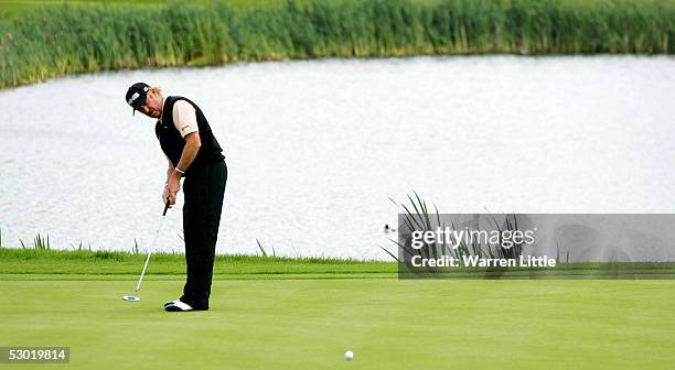 Miguel Angel Jimenez of Spain putts out the 14th green during the third round of The Celtic Manor Wales Open 2005 at The Celtic Manor Resort on June...