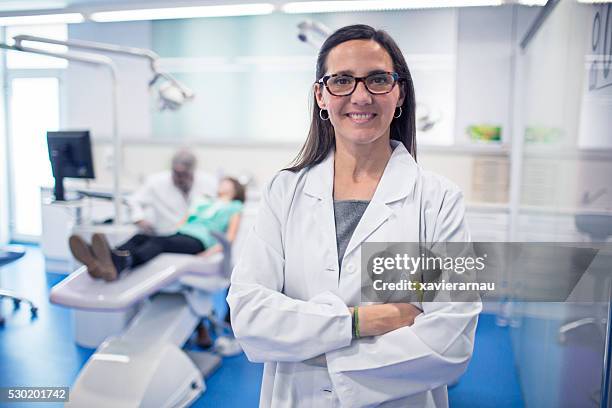 portrait of female dentist - dental office front stock pictures, royalty-free photos & images