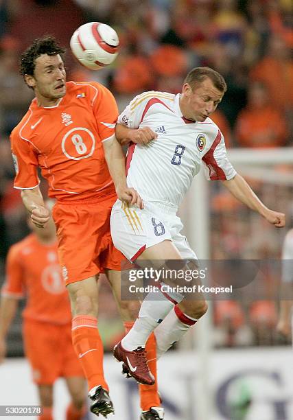 Mark van Bommel of the Netherlands and Dorinel Munteanu of Romania go up for a header during the World Cup qualification match between Netherlands...