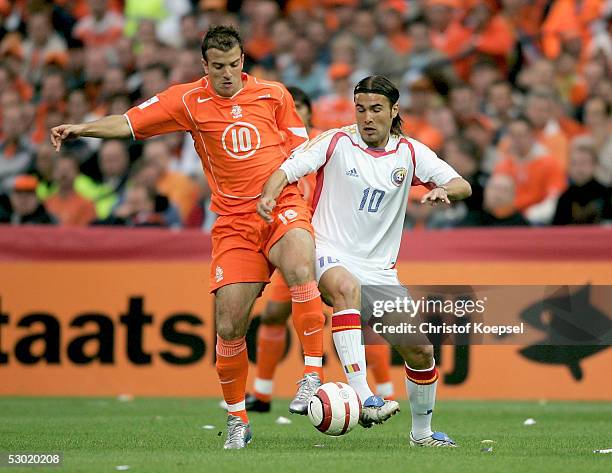Rafael van der Vart of the Netherlands is tackled by Adrian Mutu of Romania during the World Cup qualification match between Netherlands and Romania...