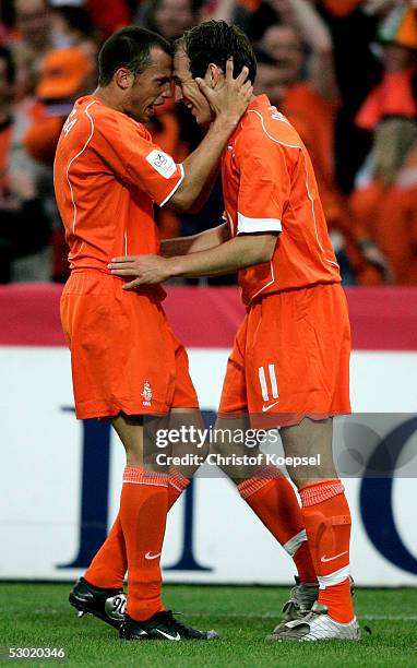 Johnny Heitinga of the Netherlands embraces Arjen Robben after scoring his first goal during the world cup qualification match between the...