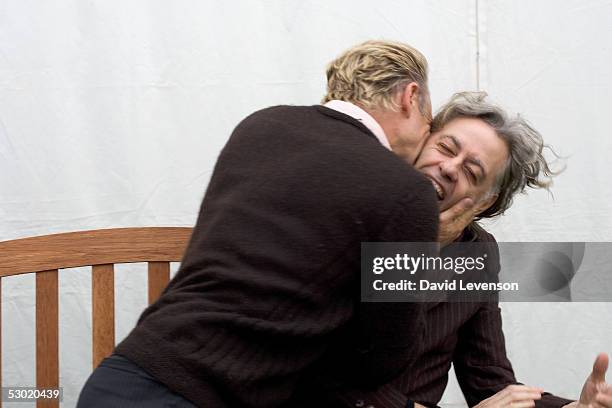 Sting kisses Sir Bob Geldof whilst joking that their birthdays are within a few days of each other as they both appeared at "The Guardian Hay...