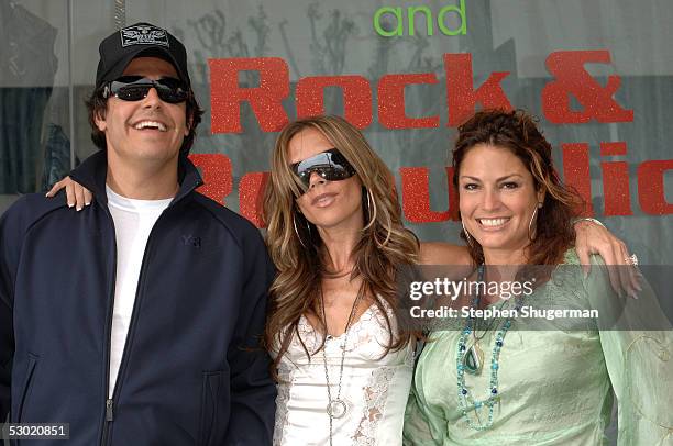 Rock & Republic executive Michael Ball, singer Victoria Beckham and Rock & Republic executive Andrea Bernholtz attend a promotion for Ms. Beckham's...