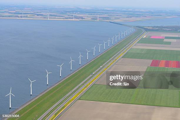 aerial view on wind turbines with fields of tulip flowers - flevoland stock pictures, royalty-free photos & images