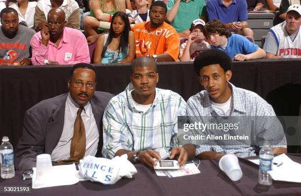 Mike Woodson, Josh Smith and Josh Childress of the Atlanta Hawks watch the Detroit Pistons take on the Miami Heat in Game six of the Eastern...