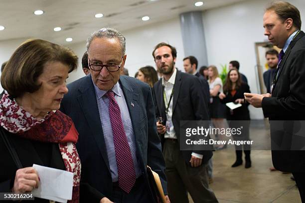 To R, Sen. Dianne Feinstein talks with Sen. Chuck Schemer as they walk to a policy meeting with fellow Senate Democrats, at the U.S. Capitol, May 10...