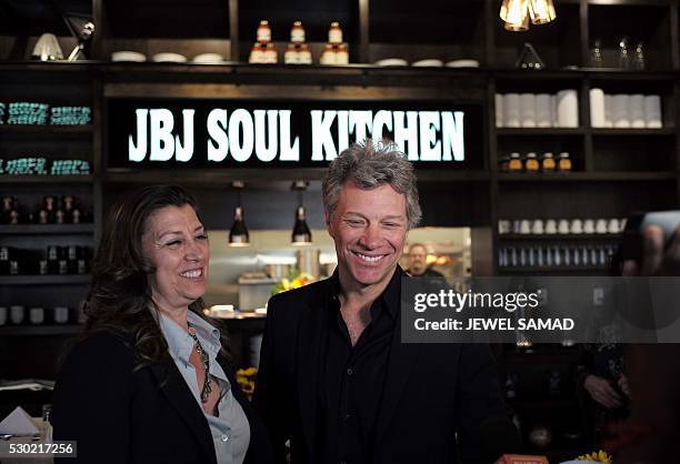 Singer Jon Bon Jovi and his wife Dorothea smile after opening the BEAT center in Toms River, New Jersey, on May 10, 2016. The Food Bank of Monmouth...