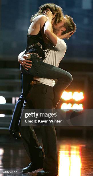 Actress Rachel McAdams and Actor Ryan Gosling accept the award for Best Kiss for The Notebook onstage during the 2005 MTV Movie Awards at the Shrine...