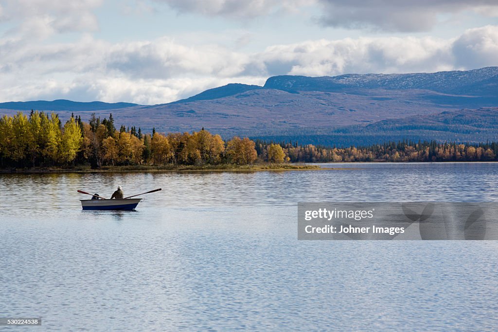 Person rowing on lake