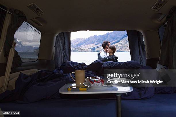 a camping meal inside a campervan. - road trip van stock pictures, royalty-free photos & images