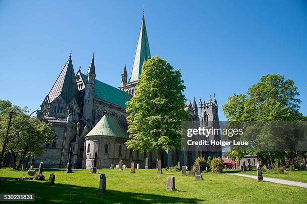 park with gravestones outside nidaros cathedral - nidaros cathedral trondheim stock pictures, royalty-free photos & images