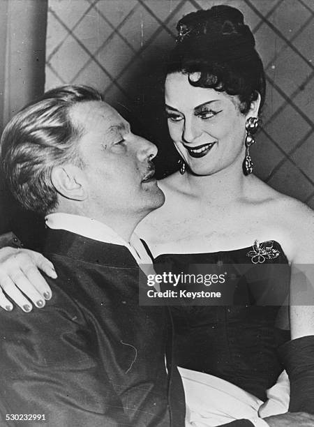 Actor Anton Walbrook with actress Elisabeth Wiedemann sitting on his lap, at an event is Dusseldorf, Germany, September 24th 1951.