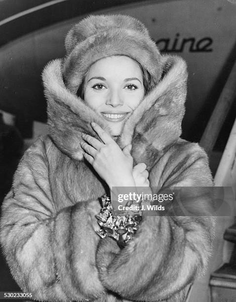 Actress Elsa Martinelli wearing a fur coat and hat, soon to star in the film 'The VIP's', arriving at London Airport, February 16th 1963.