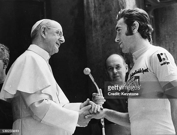 Pope Paul VI shaking the hand of champion cyclist Eddy Merckx, prior to the start of the Tour of Italy race, Vatican City, Rome, May 16th 1974.
