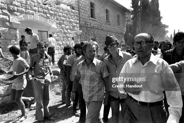 Israeli opposition leader and Likud party head Menachem Begin, R, arrives to join right-wing Jewish settlers who have fenced in the old railway...