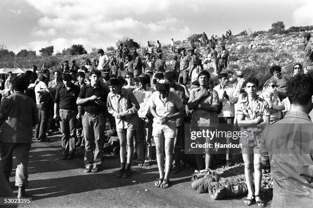 Members of the right-wing Jewish youth movement Bnei Akiva hold impromptu prayers at an Israeli army roadblock October 9, 1974 where they were...