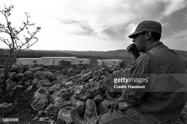 An Israeli soldier on guard duty November 21, 1979 outside the mobile home settlement of Elon Moreh on the western side of the West Bank Palestinian...