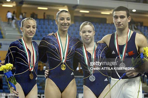Medalists of the French team, Emilie Lepennec, Isabelle Severino, Marine Debauve and Yann Cucherat pose on the podium in the 'Phonix' Sport Hall of...