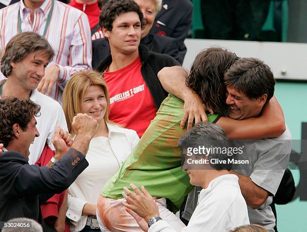 Rafael Nadal of Spain celebrates winning with his coach and uncle, Tony, during the Mens Final match on the fourteenth day of the French Open at...