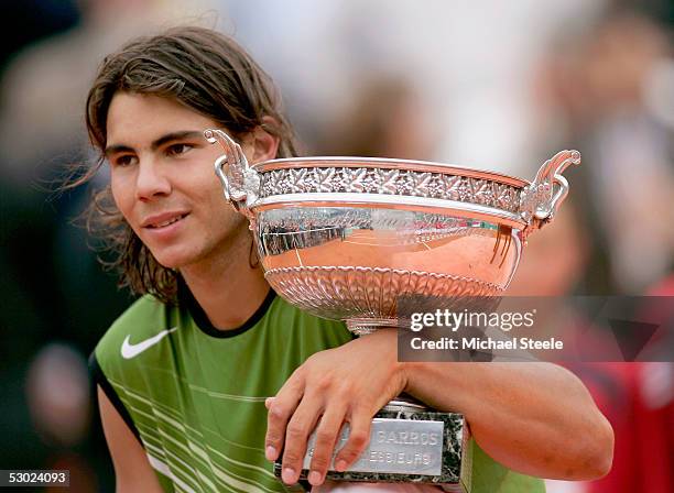 Rafael Nadal of Spain poses with the winners trophy after his 3-1 sets victory over Mariano Puerta of Argentina during the Mens Final match during...