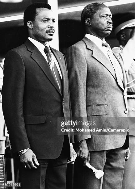 President Daniel arap Moi of Kenya and President Denis Sassou-Nguesso of the Republic of Congo, standing together at a meeting in Kenya, circa 1980.